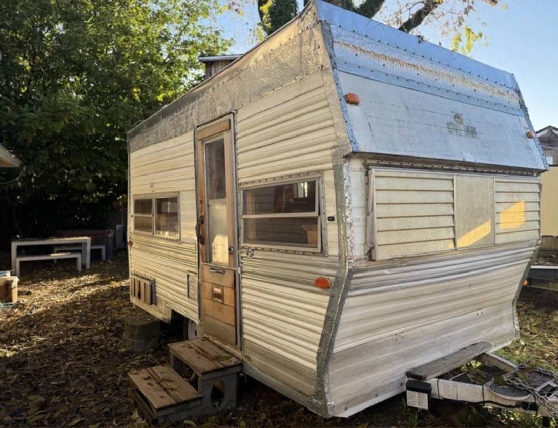 The Cousin Eddie parked in the yard in late afternoon light