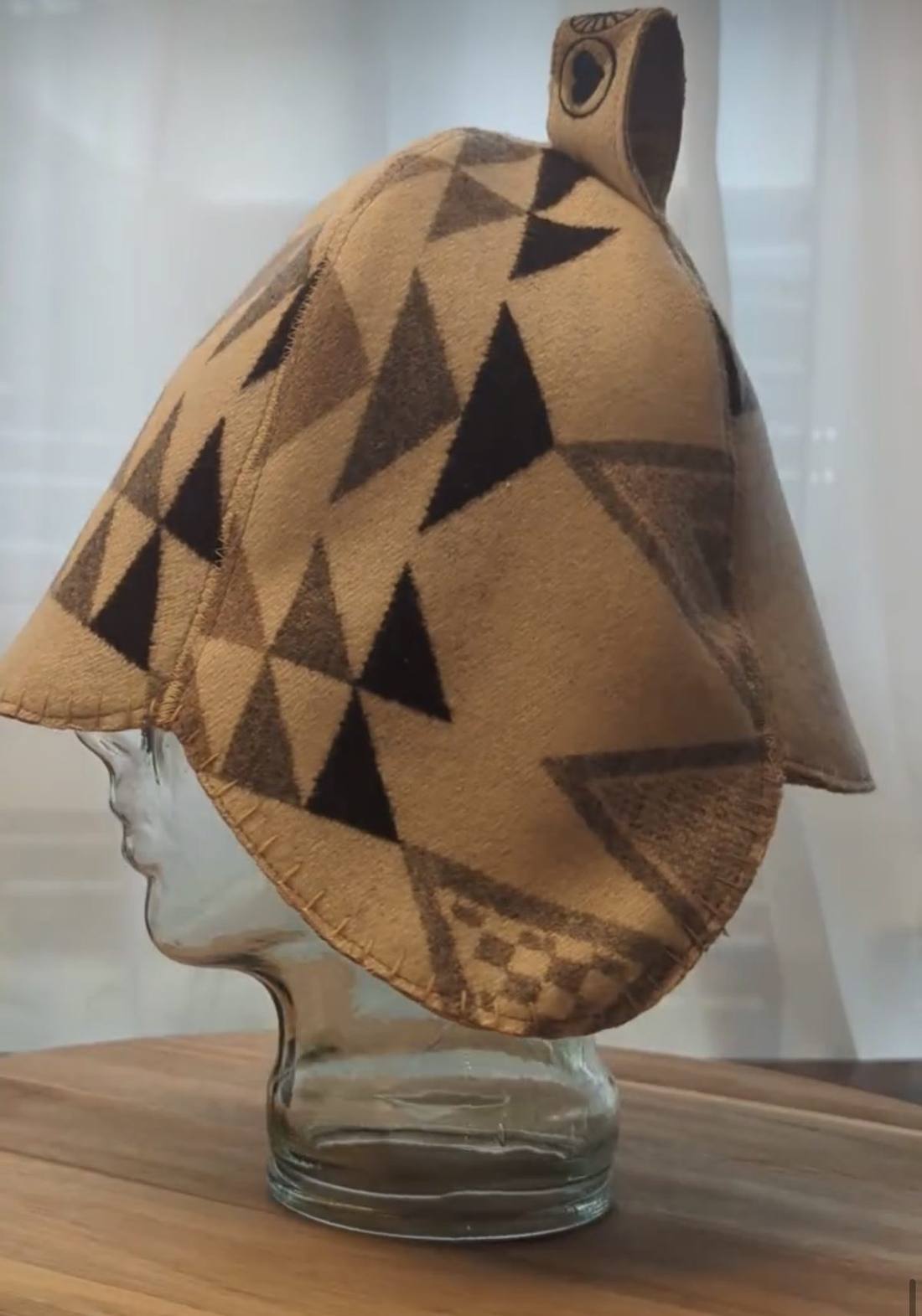 Tan wool sauna hat with a dark triangle pattern